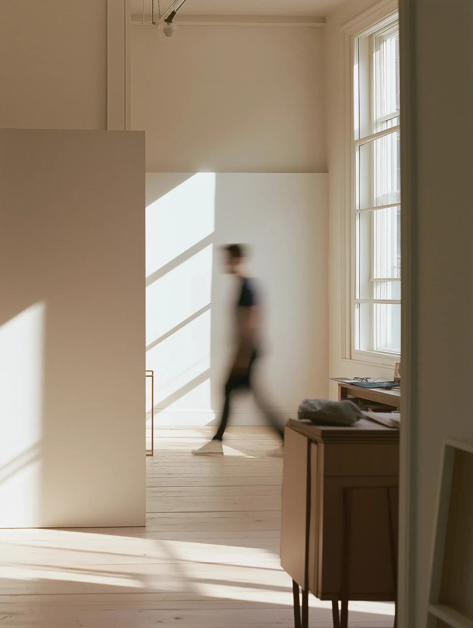 Calm modern European studio with a minimal tech workstation